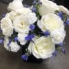 white roses with blue statice and delphinium