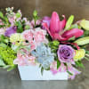 pink spray roses, lavender roses, green hydrangea, lisianthus, pink lily in a