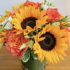 Relax in the warmth of sunflowers and orange garden roses.