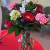 Pink and red Carnations, red Gerbera Daisies, white Capanuala, purple Statice, green