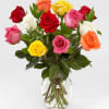 Dozen mixed colored roses arranged in a cut glass vase with a