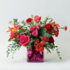 Michele is a pink clear cube vase - full of red roses