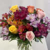 Colorful bouquet bursting with pink, yellow, &amp; orange Ecuadorian Roses, and pink