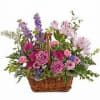 A WOVEN BASKET WITH ASSORTED PURPLE FLOWERS