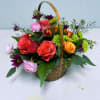 This radiant basket arrangement features cheerful ranunculus, classic roses, soft spray roses