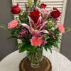 This arrangement includes Red Roses, Stargazer Lily, Pink Carnations and Wax Flower.
Lily
