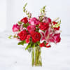 This exquisite bouquet combines the mesmerizing beauty of oriental lilies, classic red