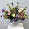 Delight in the gentle beauty of this exquisite flower arrangement nestled in