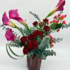 Bold red spray  roses paired with pink calla lilies create a