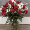 Classic red roses paired with delicate baby&rsquo;s breath, beautifully arranged in a