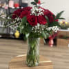 An opulent display of premium long-stem red roses, artfully arranged in a
