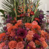 A stunning and abundant basket arrangement featuring roses, gerbera daisies, carnations, snapdragons