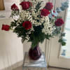Elegant and timeless, this beautiful arrangement features fresh premium red roses accented
