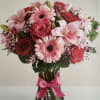 Beautiful and romantic, this pink and red mixed flower arrangement features fresh