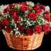 A delicate basket filled with red baby's breath roses tied with a