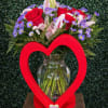A lovely red wooden heart vase (made by hand)  filled with