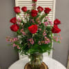 The classic and timeless vase of a dozen red roses you know