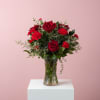 A traditional arrangement of red roses, red carnations, and fresh greens.