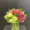 The Garnet Garden fresh floral arrangement blends rich red and burgundy tulips