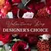 A romantic array featuring red roses accented with seasonal flowers in reds