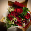 A gorgeous assortment of premium red roses in a hand tied Bouquet.
