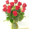 One Dozen premium long stemmed RED roses arranged in a stylish glass