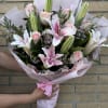 an all pink arrangement of lilies and roses 