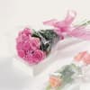 A dozen roses in Fuschia, pinks or red, beautifully wrapped and tied
