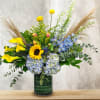 This unique design includes, hydrangea, calla lilies, sunflowers, delphinium, tulips, crespedia, thistle