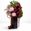 
A contemporary floral statement featuring burgundy orchids, blush roses, cascading textures, and