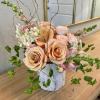 Blushing Betty is a sweet blush-colored arrangement of roses, spray roses, and