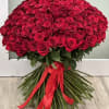 A modern bouquet of fresh cut red roses with exposed stems and