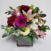 Designer's choice of mixed seasonally colored blooms and premium foliage, artfully arranged