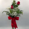 Three Red Roses done up in a bud vase with filler and
