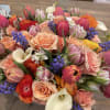 This bouquet is vibrant, cheerful and bursting with spring energy. It contains