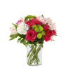 Arrangement in a glass vase includes hot pink roses, hot pink mini