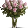 Symbolizing gentility and elegance, these dozen pink roses, punctuated with fresh greenery
