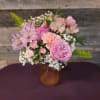 A delicate mix of blush blooms and soft pink roses with airy