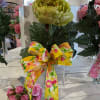 An artificial vibrant green garden rose in a bud vase with a