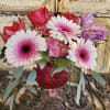 A gorgeous arrangement in a mercury glass vessel with Gerbera daisies, hydrangea