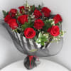 12 long stemmed roses in a bed of italian ruscus greenery and