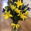 Bright Yellow Lillies Partnered With Stems Of Purple Iris 