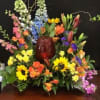 Vibrant mix of sunflower, delphinium, astromeria, lilly, and daises with touches of