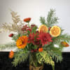 A holiday arrangement with a twist...of orange. 