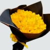 Bouquet of yellow roses wrapped in dark paper with a yellow ribbon