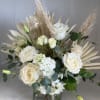 A beautifully soft and elegant arrangement in delicate shades of cream and