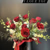 A striking arrangement of velvety red  hearts roses ,artfully composed with