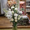 White spray roses, stock, carnations and hybrid delphinium with eucalyptus in tall