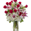 This stunning arrangement includes long stemmed red roses, hydrangeas with fragrant stargazer