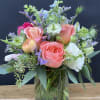 This arrangement includes a sweet mix of Garden Roses, Peonies, Lisianthus, Delphinium